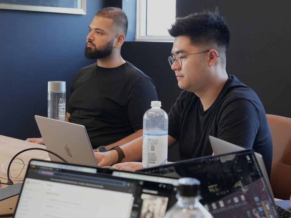 Two of the team at their laptops in an in-person client session.