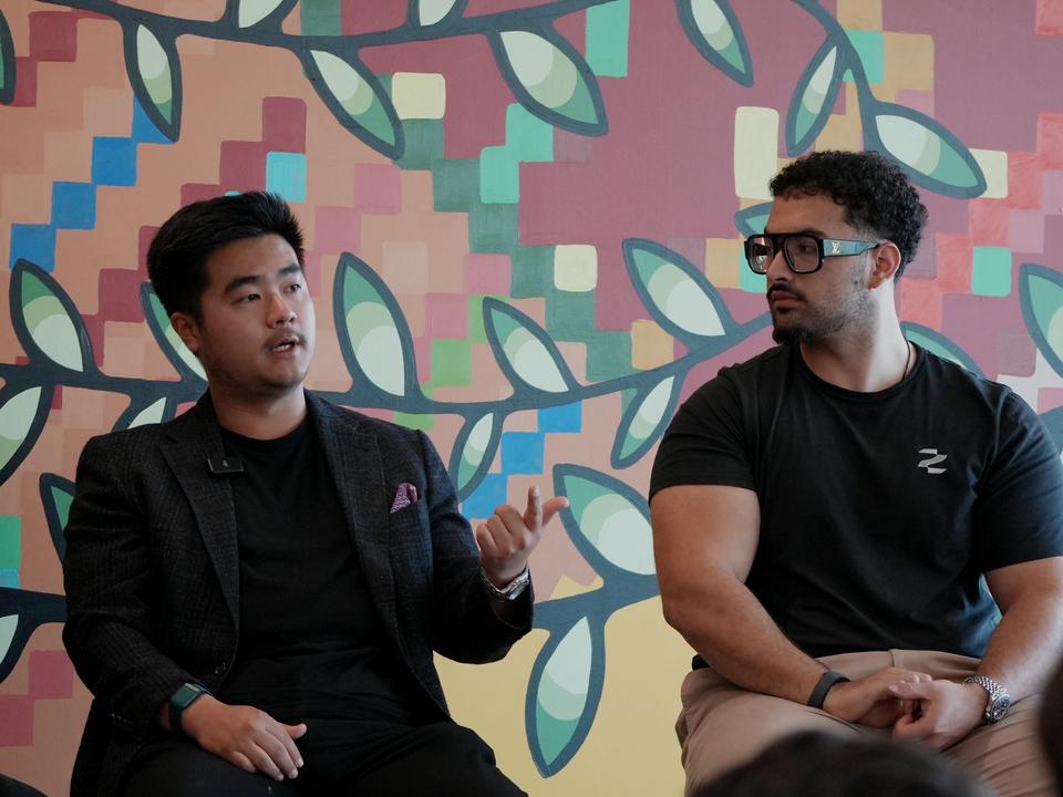 A Zero to Agent panel talk in front of a bright mural.